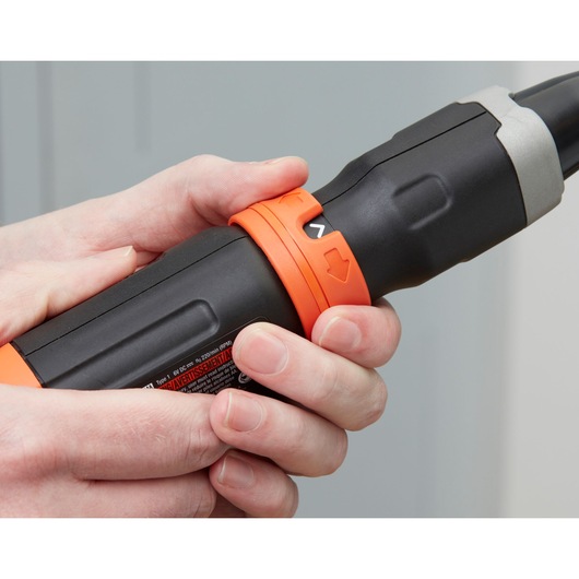 Close-up photo of BLACKDECKER BCF601C cordless screwdriver being held by hand, showing orange and black grip.