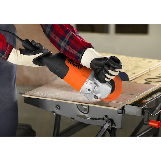 Material being grinded with the BLACK+DECKER® 2200W 230mm Electric Large Angle Grinder.