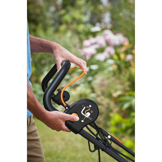 Close up view of the BLACK+DECKER BEOEP320 30cm 1200W Corded Scarifier power on button and pull handle