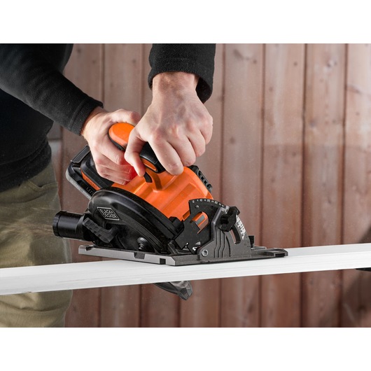 BLACKDECKER BLCCS78E1 circular saw cutting wood, close-up action, orange and black tool.