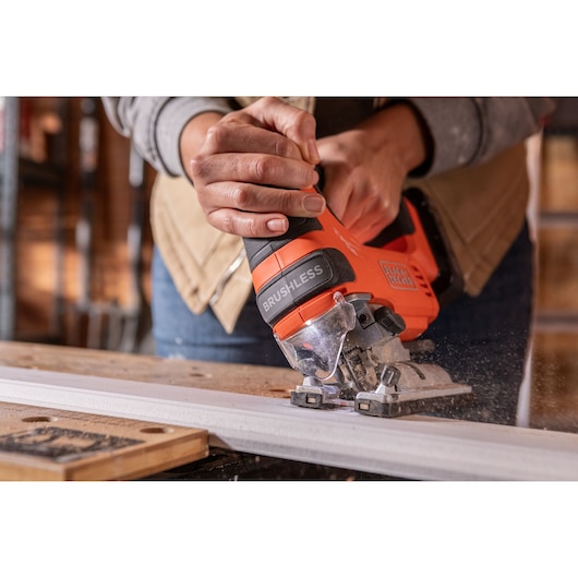 BLACKDECKER BLCJS78E1 jigsaw cutting wood, close-up of hands operating orange brushless power tool.