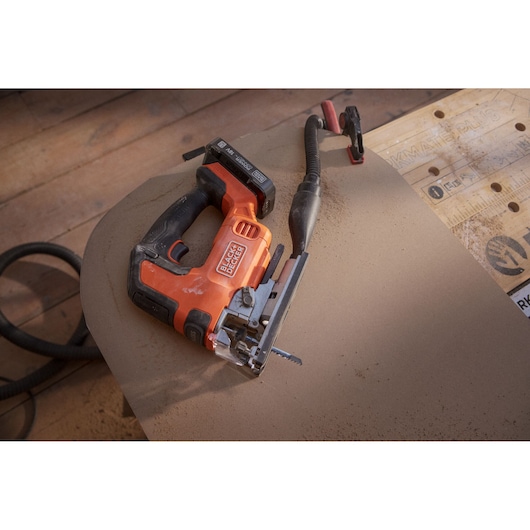 BLACKDECKER BLCJS78E1 jigsaw on wooden floor with power cord, photo at angle.