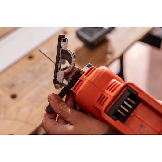 Photo of BLACK+DECKER BLCJS78E1 jigsaw close-up, showing blade installation in a workshop.