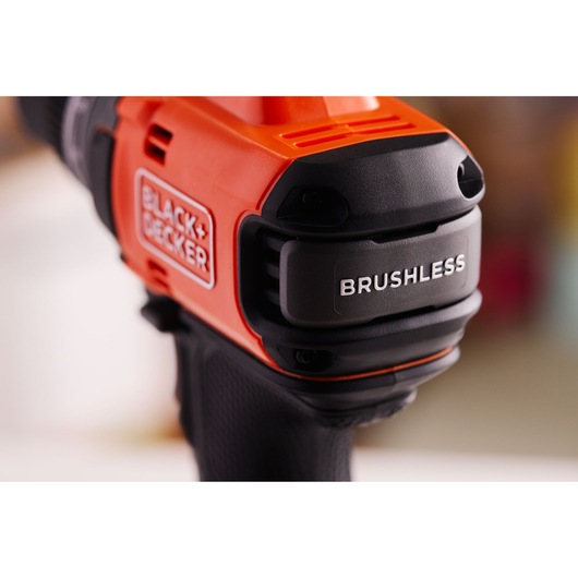 Close-up of BLACK+DECKER BLD682D1 brushless drill, orange and black colors, product photography.