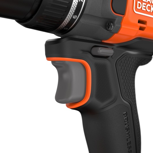 BLACK+DECKER BLD782E1K cordless drill close-up, showing black and orange ergonomic handle and trigger, side view.