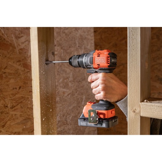 BLACKDECKER BLD782E2K cordless drill in use drilling wood, orange and black design.