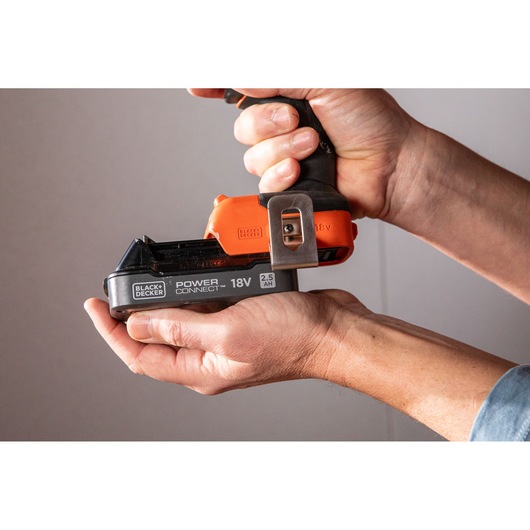 Close-up photo of BLACK+DECKER BLD783E2K 18V cordless tool handle with battery, held in hands.