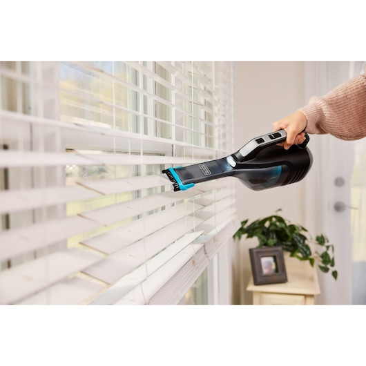 Cordless handheld vacuum cleaner with charging base and onboard LED