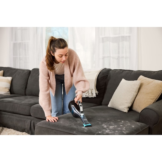 Cordless handheld vacuum cleaner with charging base and onboard LED