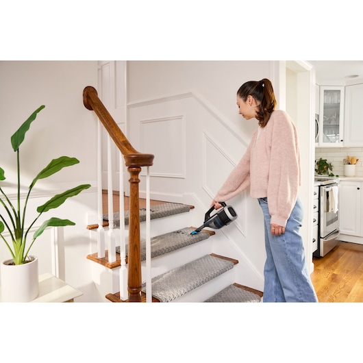 Cordless handheld vacuum cleaner with charging base and onboard LED