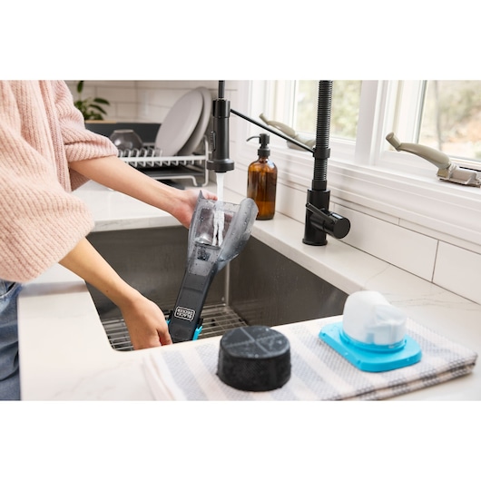 Cordless handheld vacuum cleaner with charging base and onboard LED