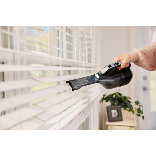 Cordless handheld vacuum cleaner with jack plug and onboard LED