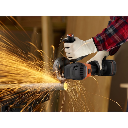A metal bar being cut with the BLACK+DECKER® 18V POWERCONNECT™ Brushless Angle Grinder.