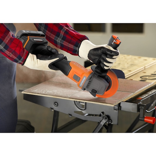 A metal sheet being cut with the BLACK+DECKER® 18V POWERCONNECT™ Brushless Angle Grinder.