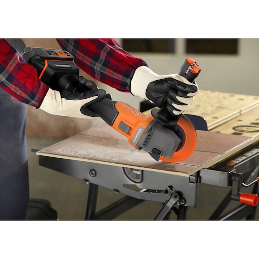 A metal sheet being cut with the BLACK+DECKER® 18V POWERCONNECT™ Brushless Angle Grinder.