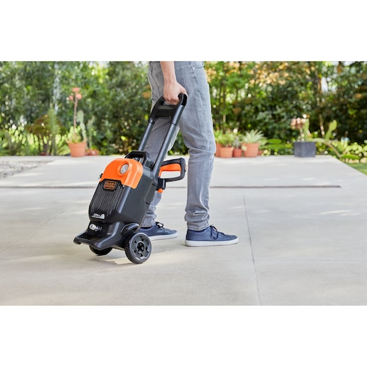 The BLACK+DECKER 2000W Corded Pressure Washer (150 Bar) being wheeled.