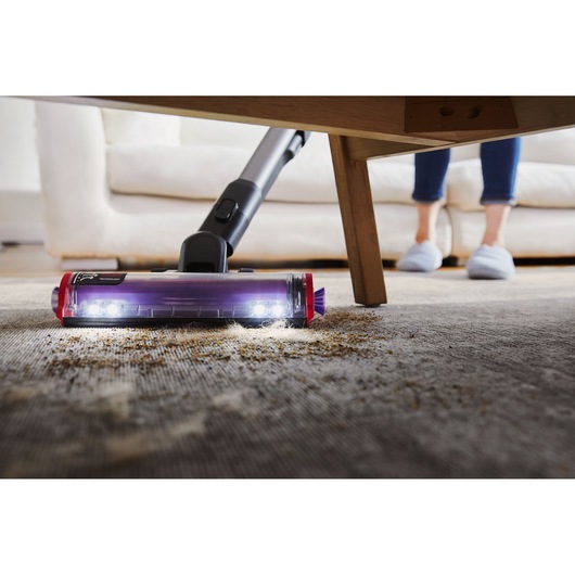 BLACK+DECKER SUMMITSERIES cordless stick vacuum vacuuming debris under coffee table