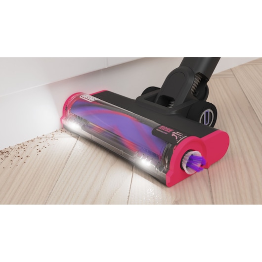 The floorhead in action, demonstating the edge-to-edge cleaning and LED headlights - BLACK+DECKER SUMMITSERIES select Pet cordless stick vacuum.