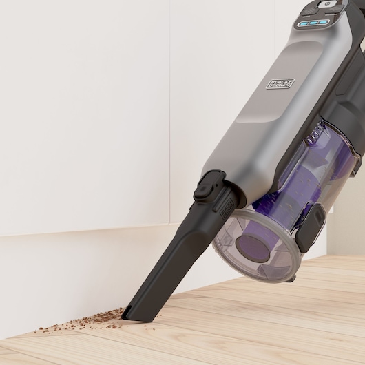 The crevice tool attachment in use with the BLACK+DECKER SUMMITSERIES select Pet cordless stick vacuum.