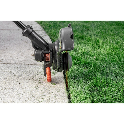 A lawn border being trimmed using a BLACK+DECKER® STRIMMER® with the String To Blade STRIMMER® Conversion Kit.