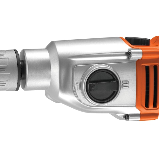 Close-up view of a BLACK+DECKER drill's mode selector switch showing numbered settings on a metallic and orange body.