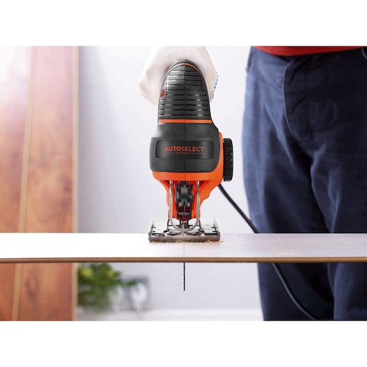 A wooden sheet being cut using the BLACK+DECKER® 550W AUTOSELECT® Pendulum Jigsaw.
